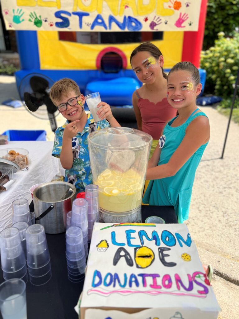 Young philanthropists hold a lemonade stand in support of the Farley Foundation.